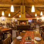 Rhino Lodge dining room interior with cosy fireplace